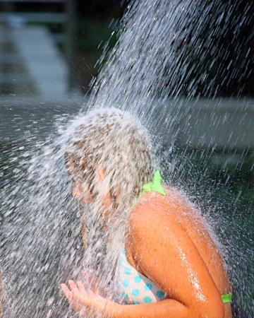 A girl standing under Crown Fountain in Chicago