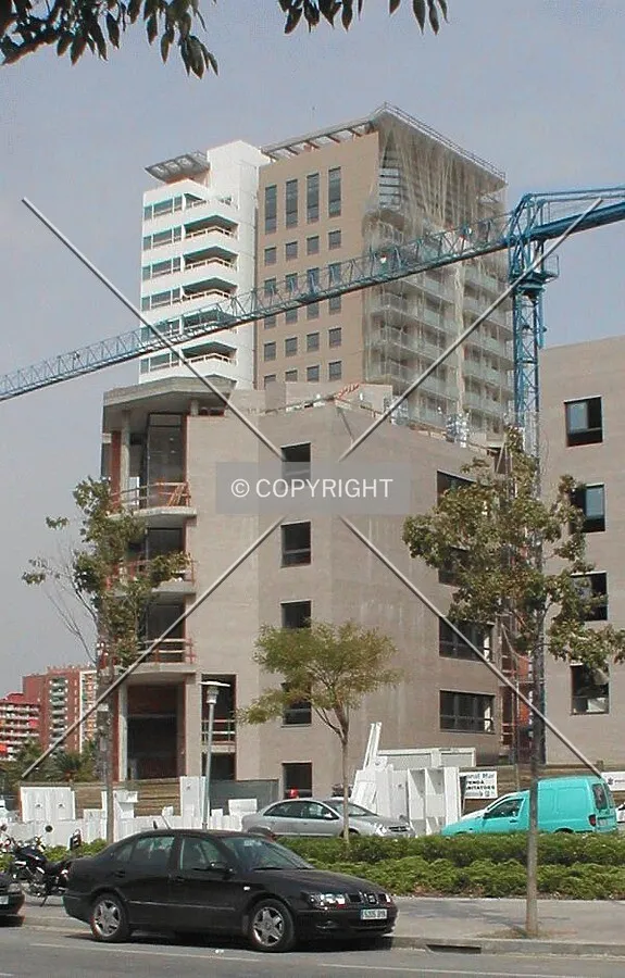 View of the front of the building with low-rise construction in the foreground