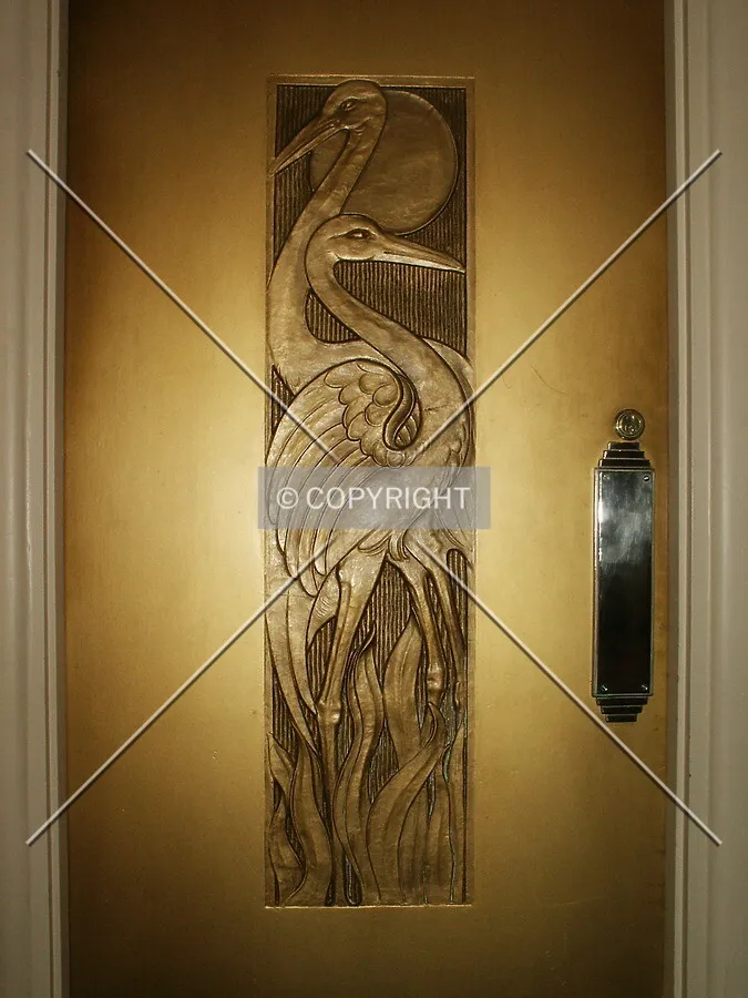 Brass cranes on a door off the lobby