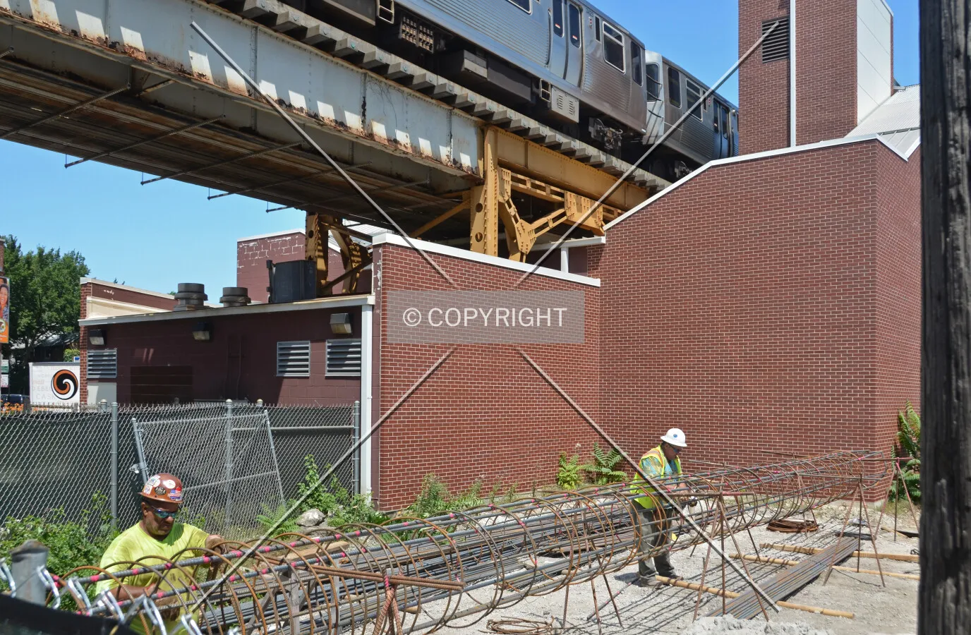 Workers assembling rebar cages for caissons. July 15, 2015