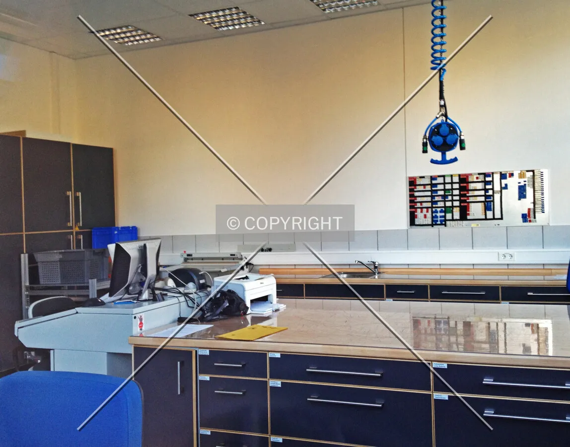 A room in a fire station including a computer and other fire fighting equipment