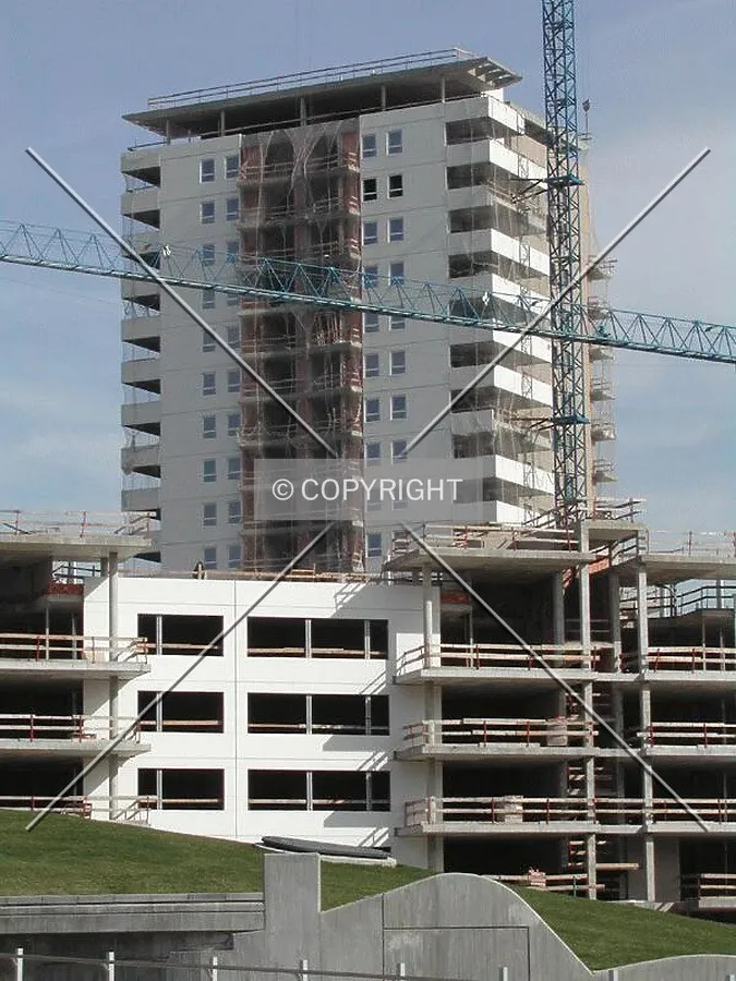 Construction rising over the low-rise apartments