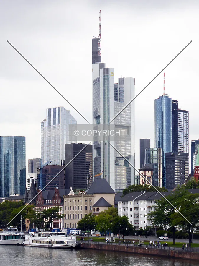 Commerzbank Tower on a cloudy day, as seen from the Main river shore