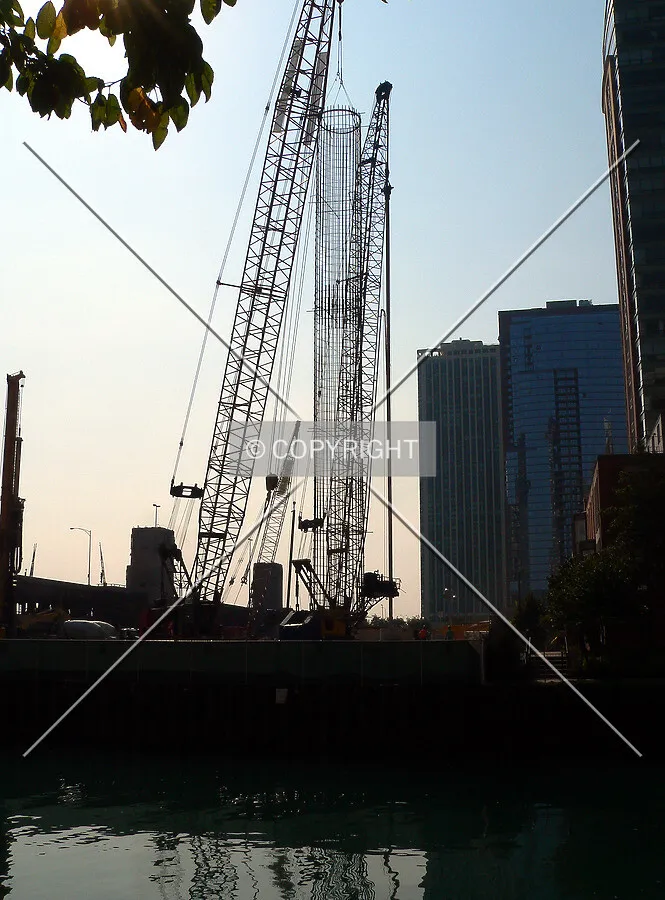 Preparing to lower a rebar cage into position