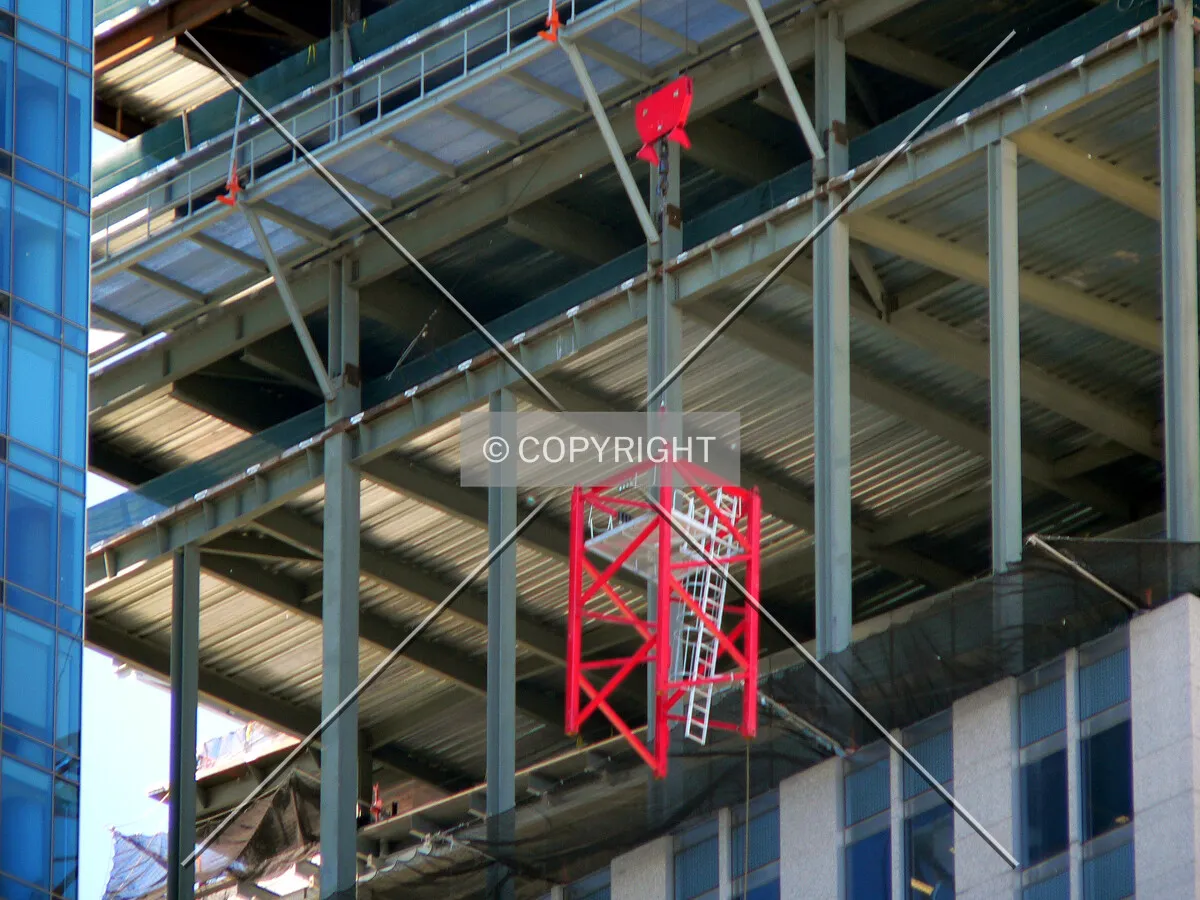 Raising a section of tower crane into position