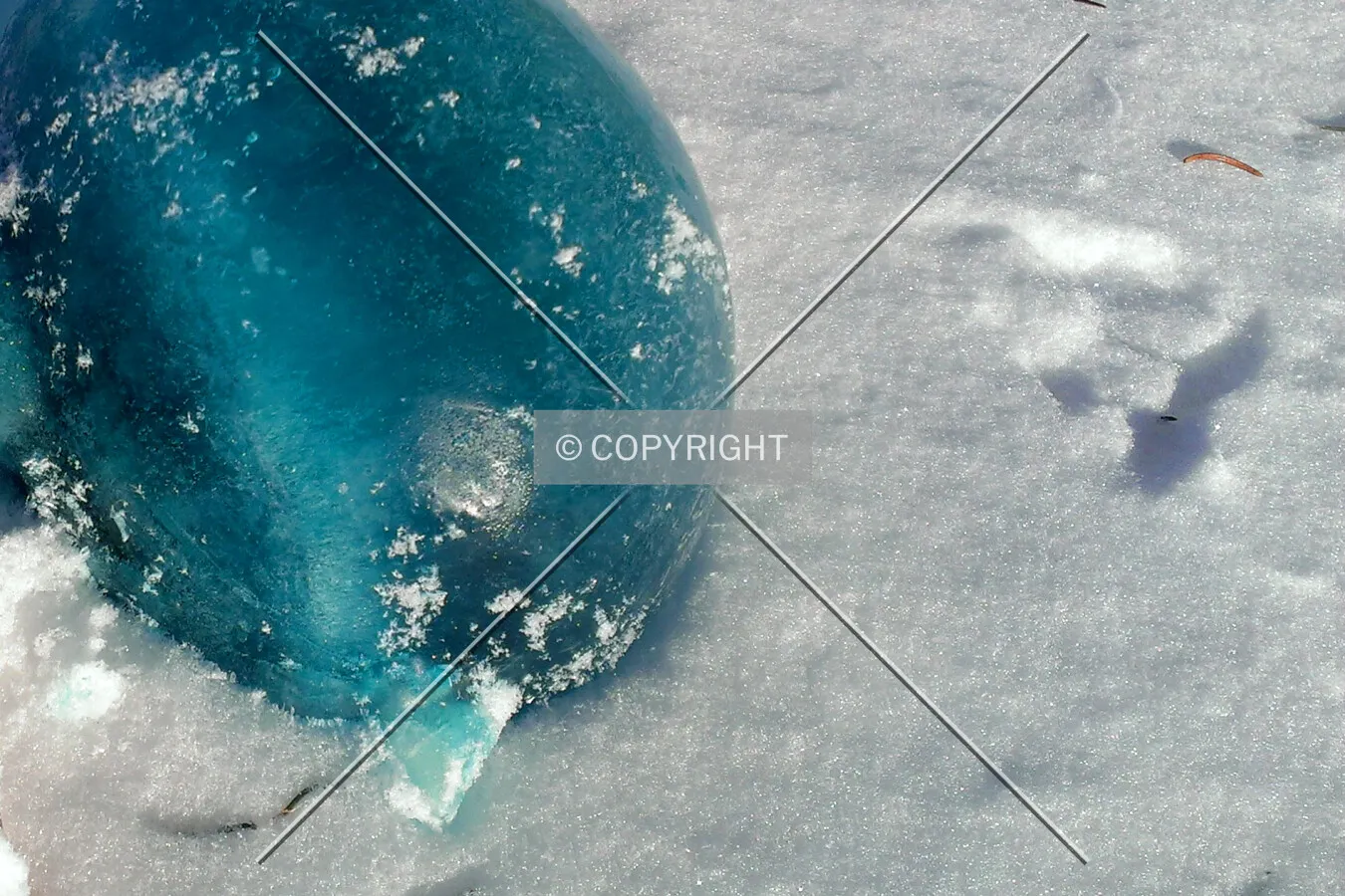 A blue ice ball in snow