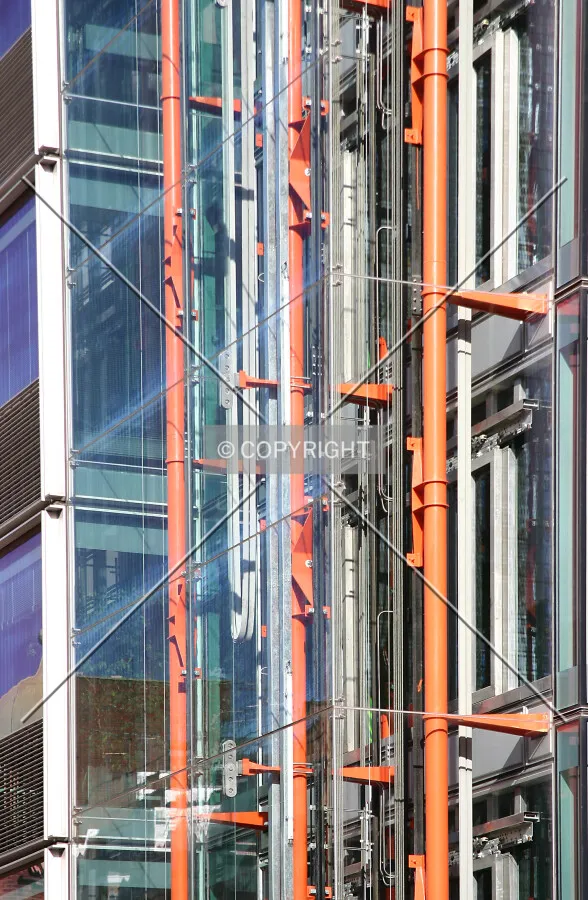 View into the glazed lift shaft showing the exposed steel in classic Rogers bold colours