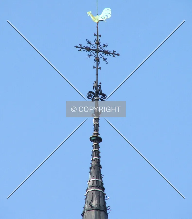 The wrought iron cross on the spire's tip