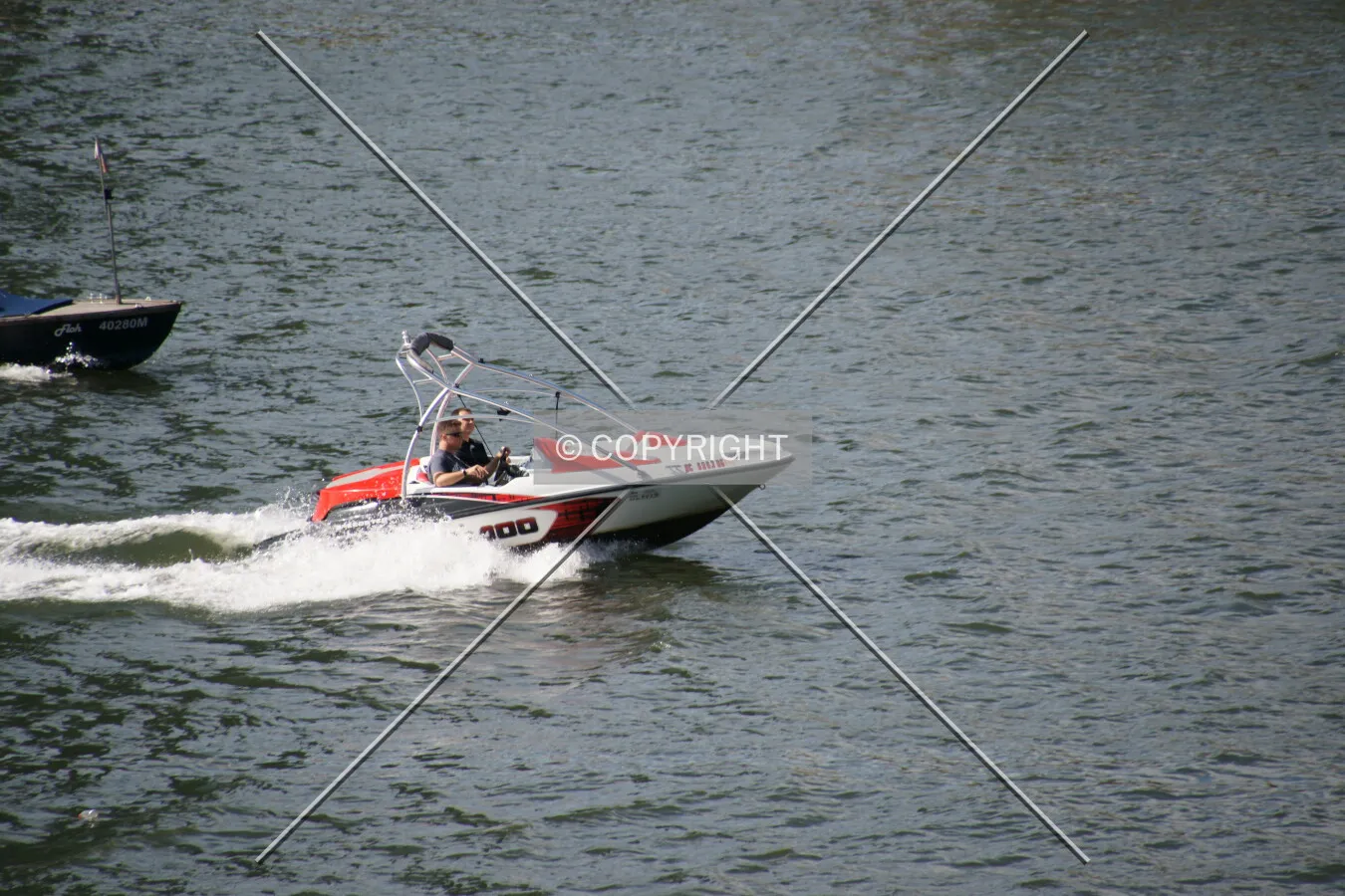 Two men drive a small boat
