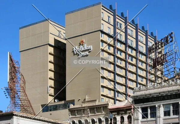 Top floors from the south on Camp Street, with signs atop Canal Street buildings