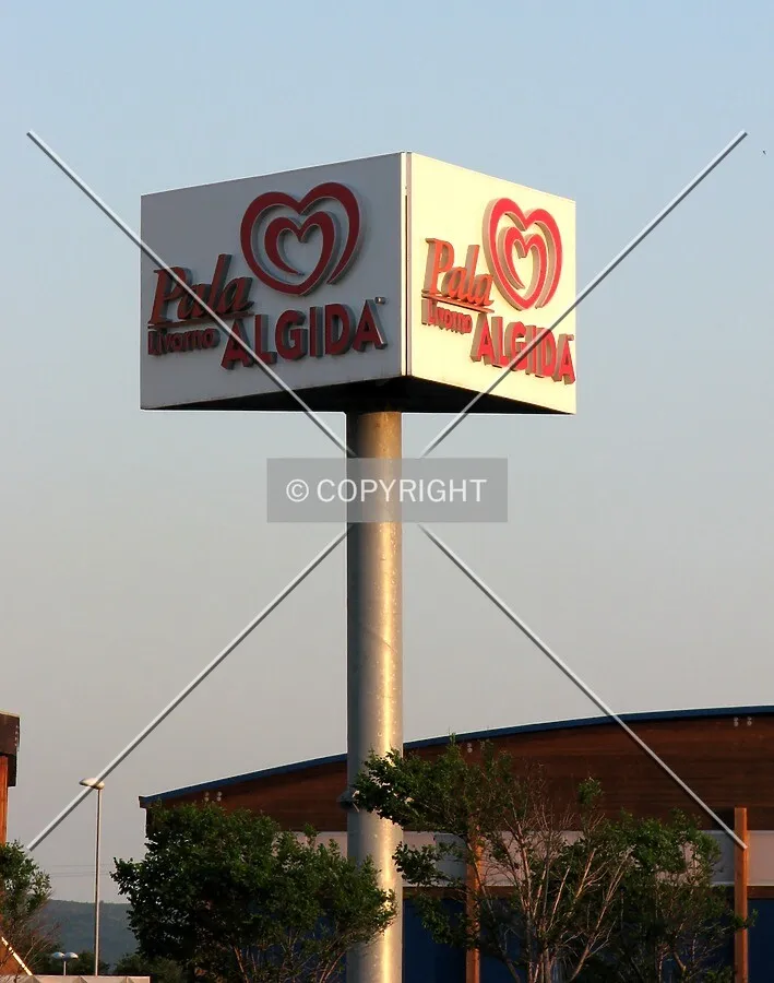 The building logo in the parking lot