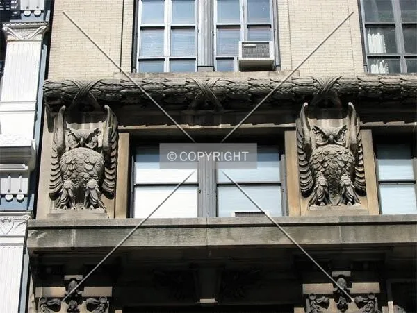 Six-foot masonry owls at the fourth floor
