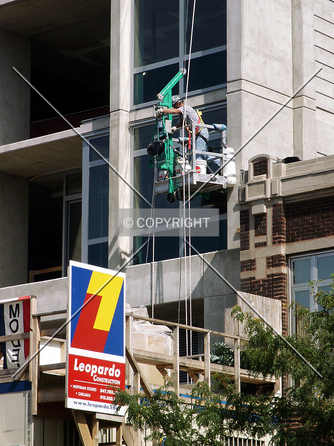 Worker hanging in front of the southwest corner