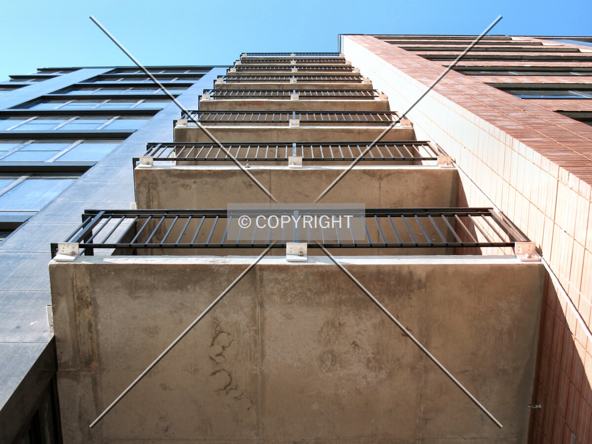 Looking up a set of balconies from 2nd Street South