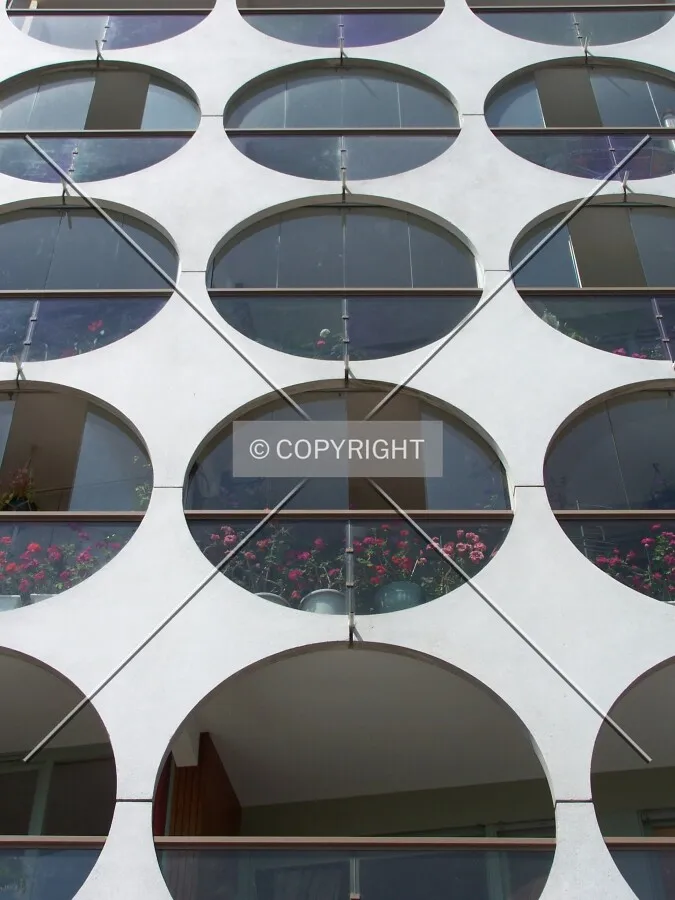 Looking up at circular details around the balconies