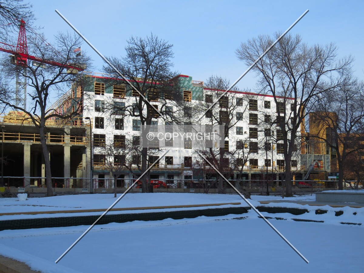Partial view through trees along Hennepin Avenue