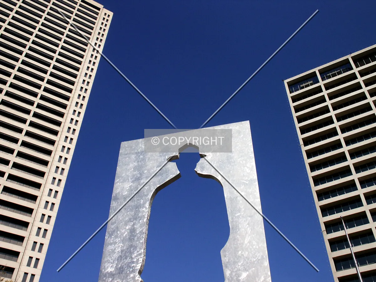 An invisible Texan stands between two office buildings