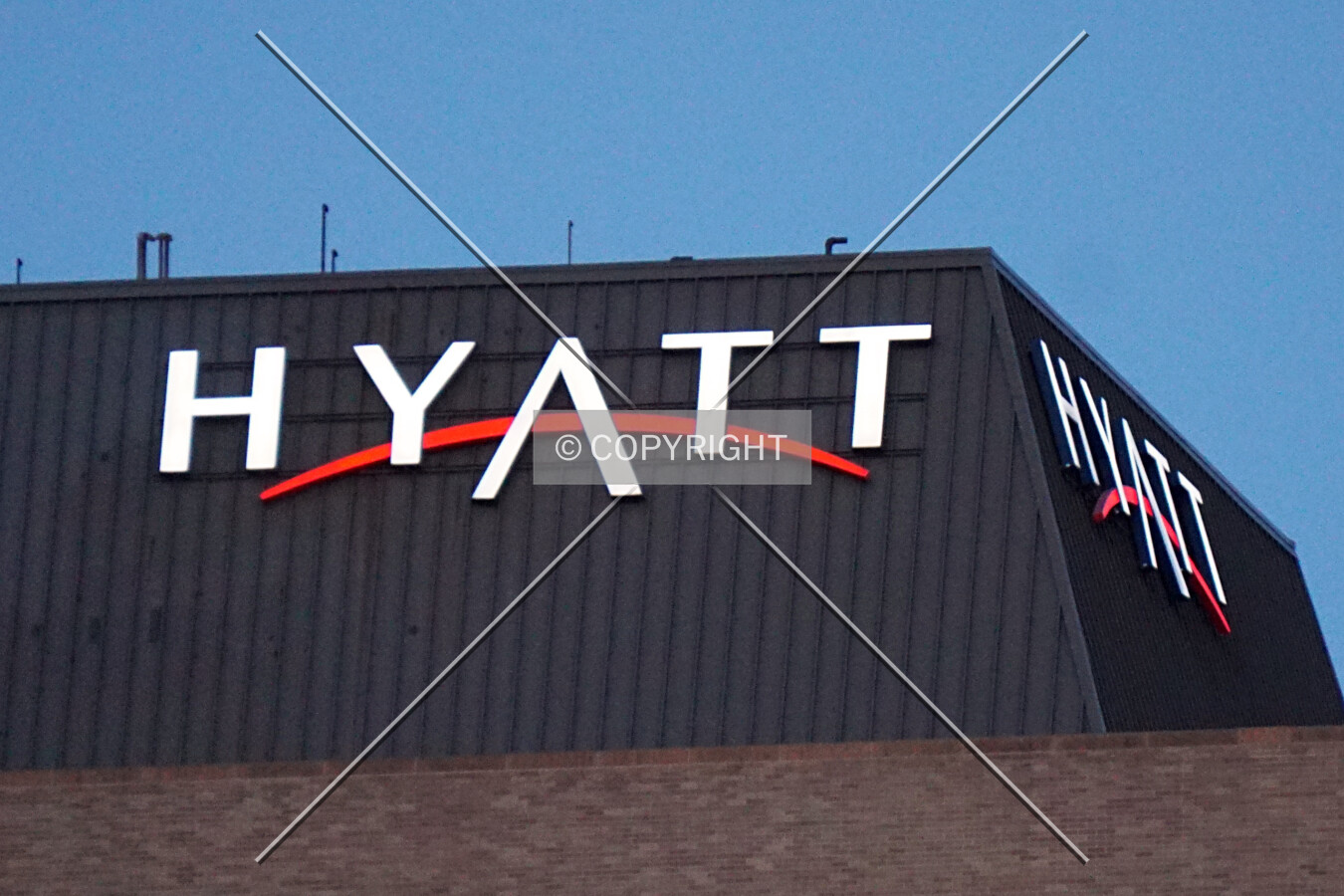 The Hyatt logo at the southwest corner in the evening; June 12, 2017