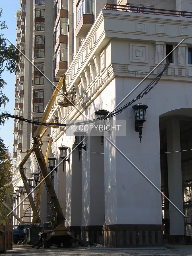 Workers painting the façade