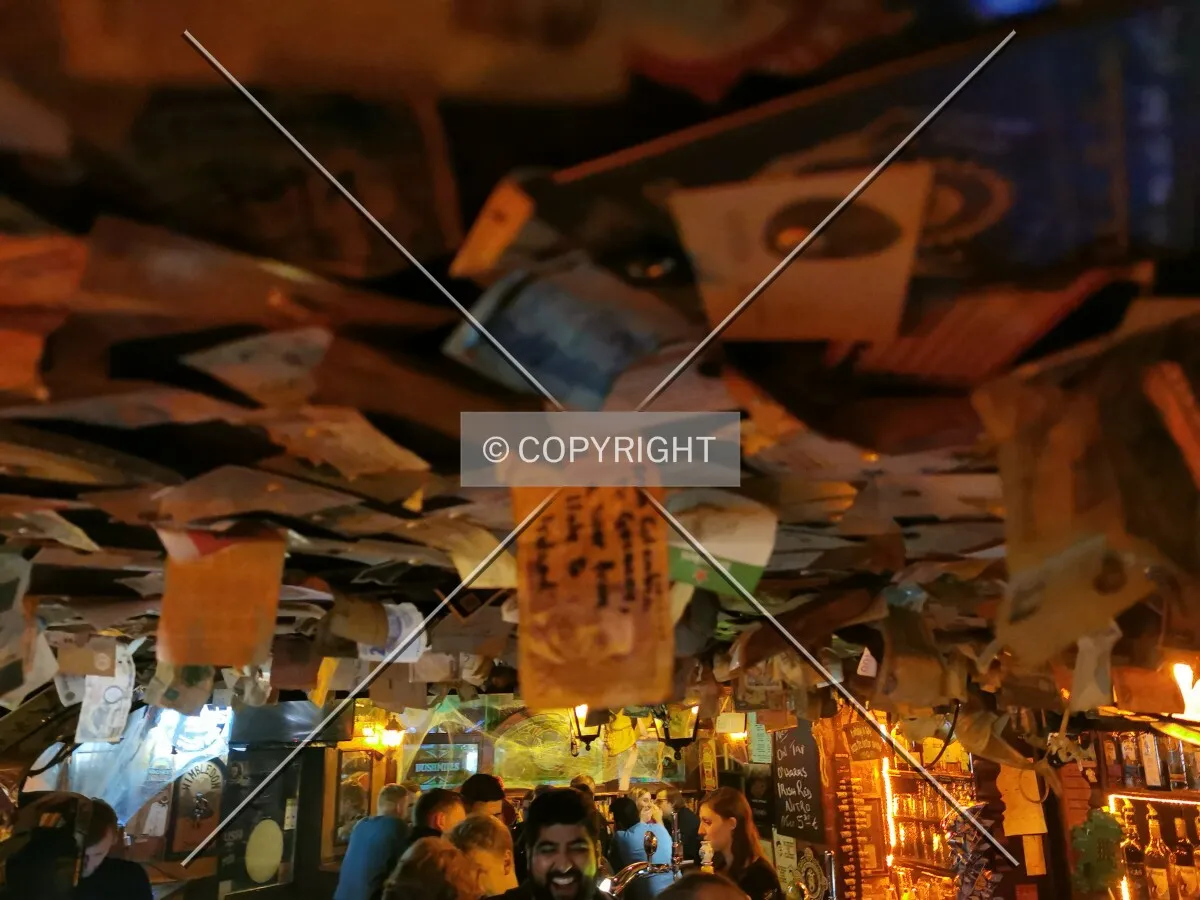 Papers at the ceiling of a bar
