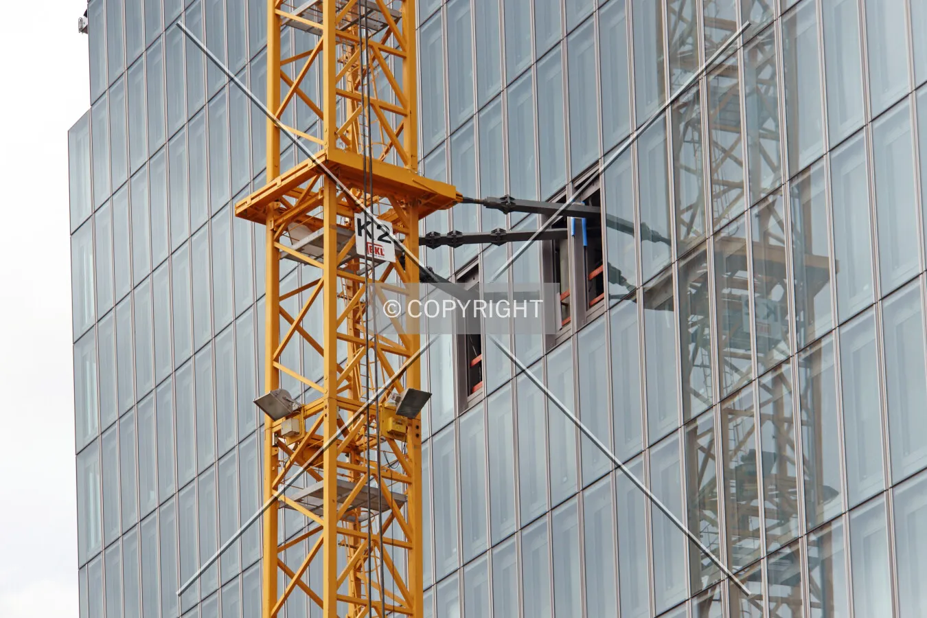 The crane is connected to the structure during the construction phase in order to gain stability