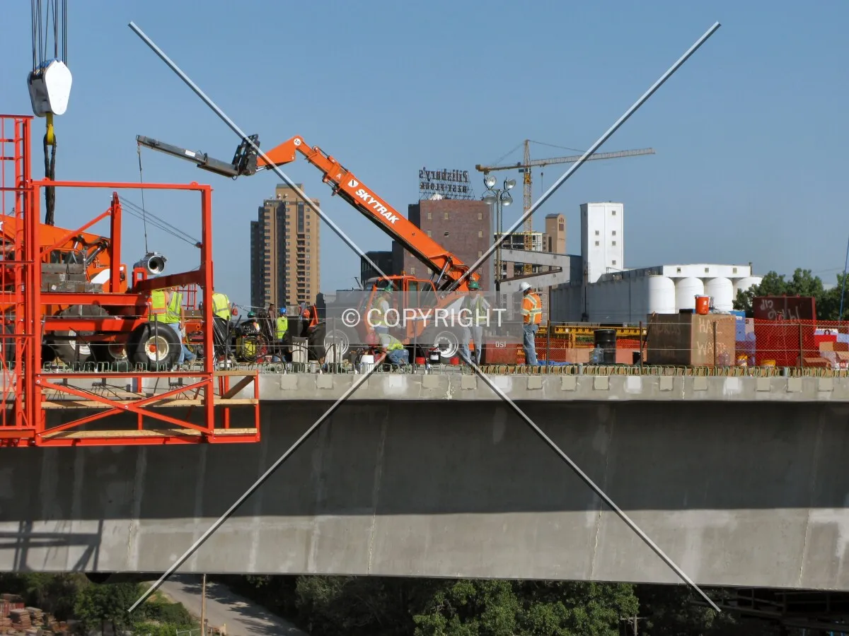 Partial skyline beyond workers on the center span