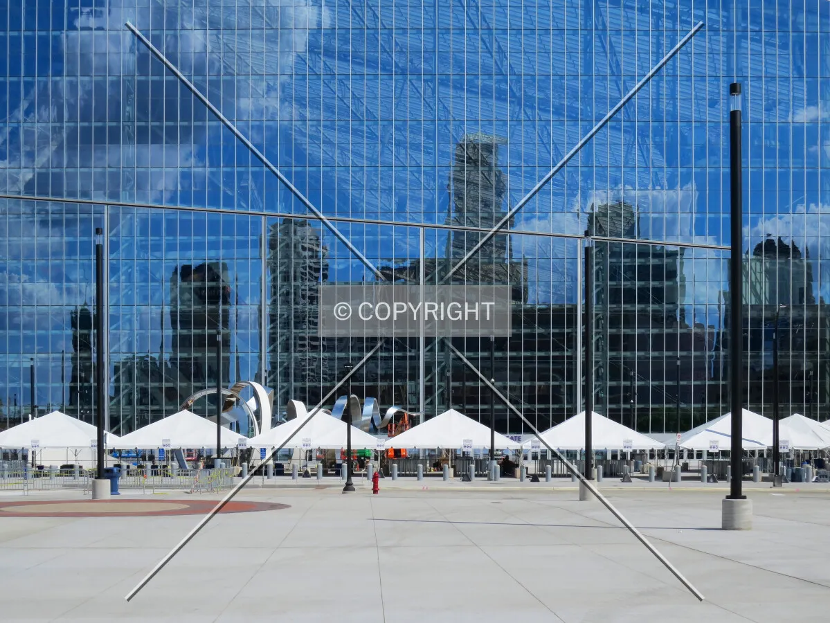 Glass facade on the west side reflecting part of the downtown skyline