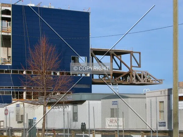 Cantilever looming beyond the construction trailers
