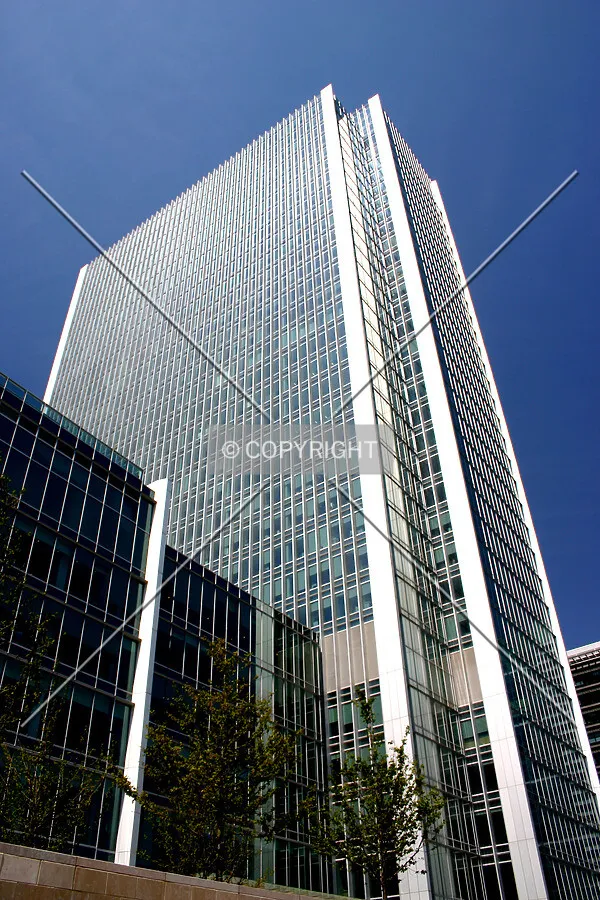 The façade glints in the early summer sun
