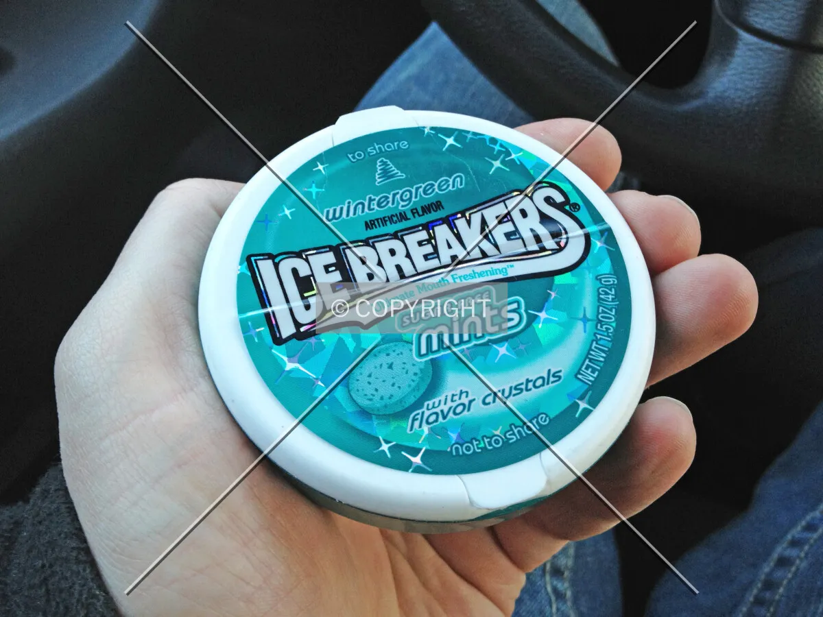 Wintergreen Ice Breakers - sugar free mints - in the hand of a man