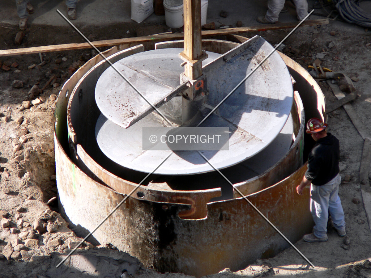 Lowering a drill bit into the caisson hole