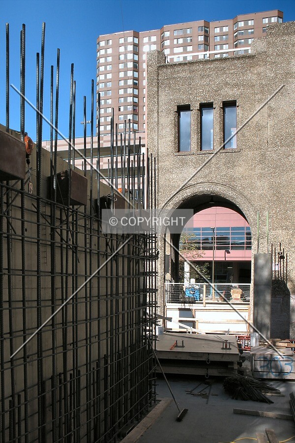 Porte-cochere on original Ivy Tower, with rising rebar; Symphony Plaza in the background