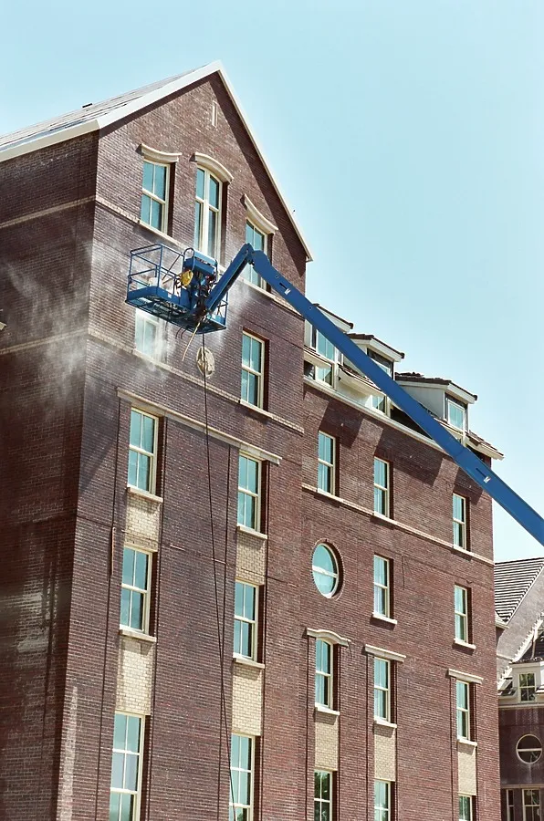 Pressure washing the new brick facade