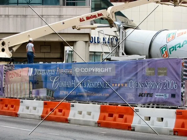 Construction worker overseeing concrete work from above Washington Street