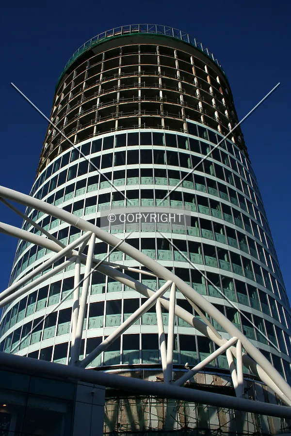 Looking up from the base at the facade's progress