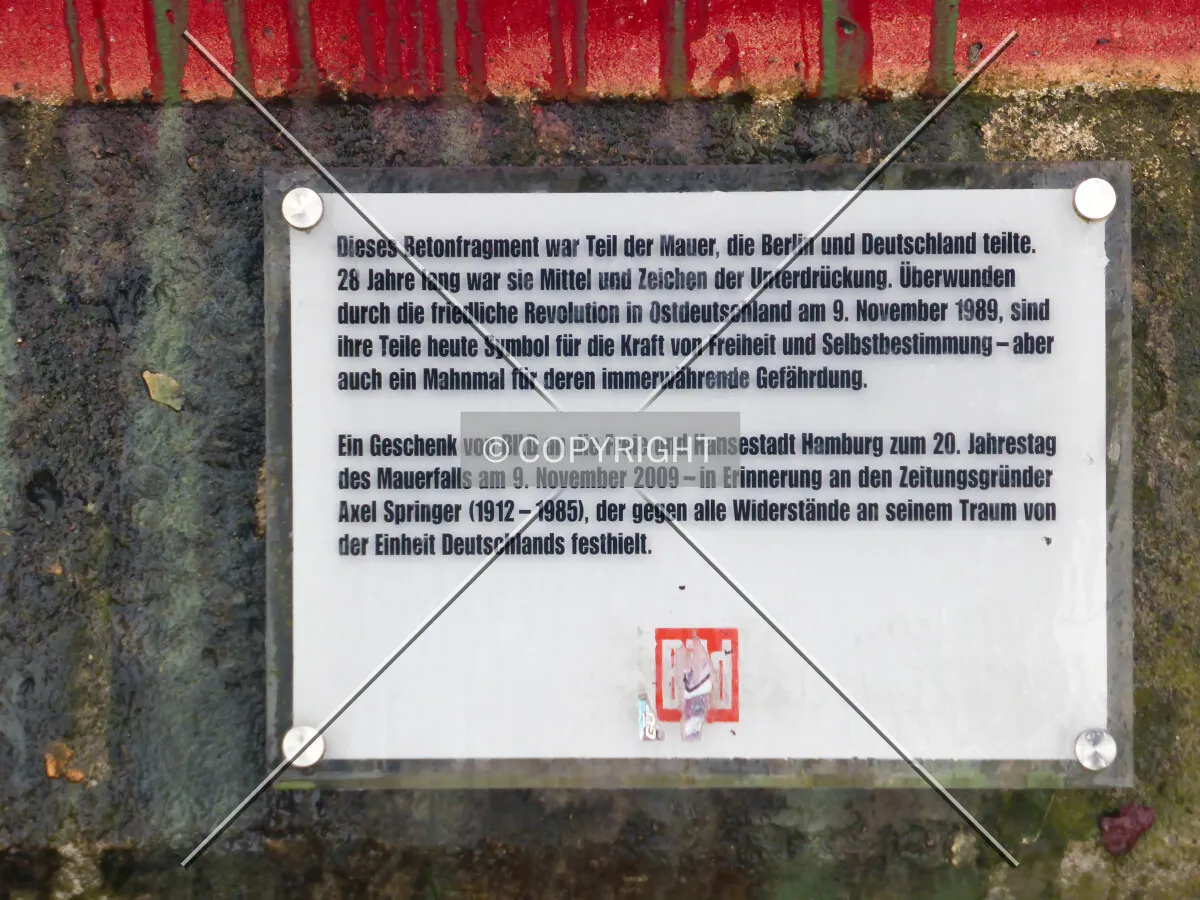 Sign explaining that Axel Springer AG donated this piece of the Berlin wall in 2009 to the city of Hamburg