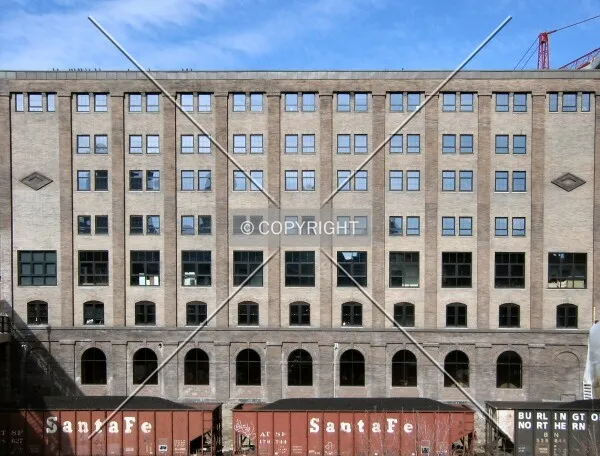 Long southeast facade, over railroad cars holding coal