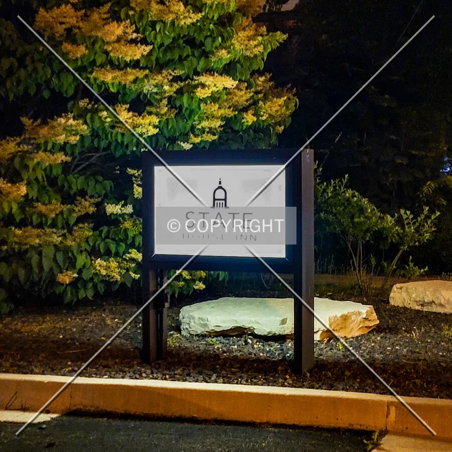 Sign at the east parking lot exit at night; June 11, 2021