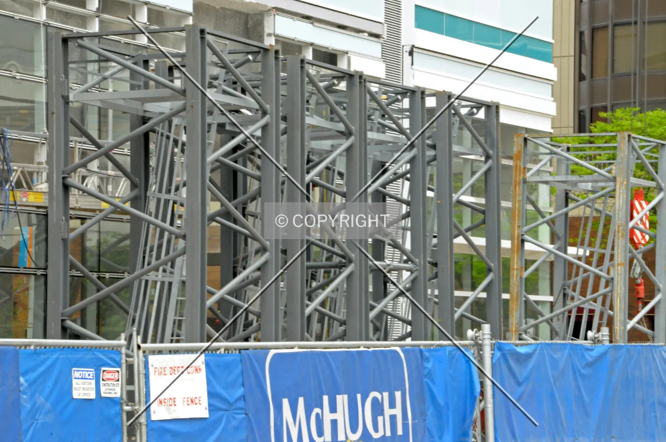 Sections of dismantled tower crane lined up along McClurg Court