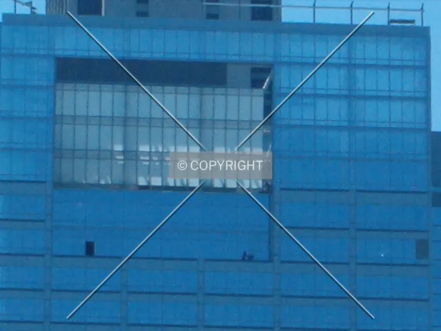 Close-up of top on east side with workers present