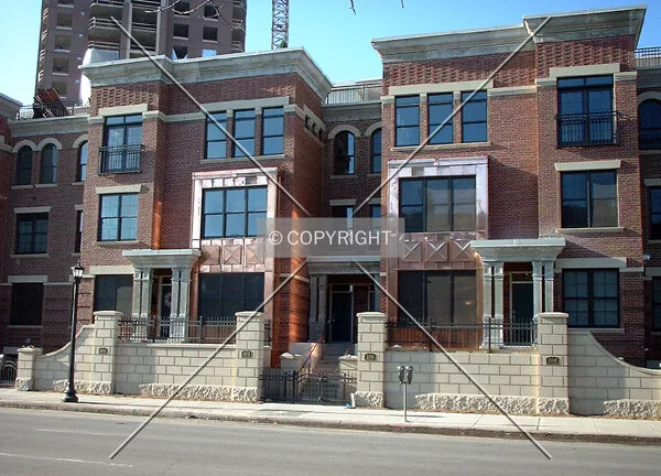 Completed rowhomes on Portland Avenue, tower rising behind