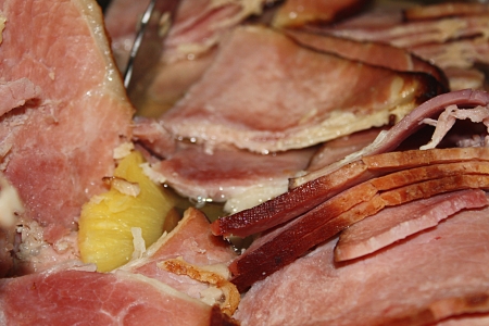 A cooked ham and pineapples