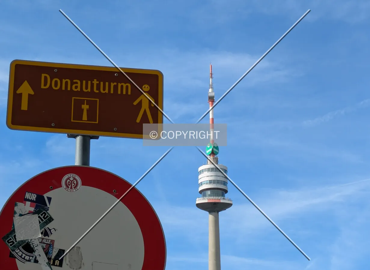 Directional signage in Donaupark and the top half of the tower from the southeast