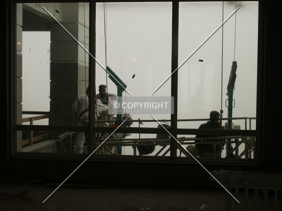Workers painting the exterior columns