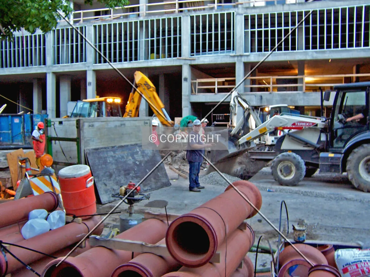 A city workcrew installing a water main connection under Grace Street to the new building