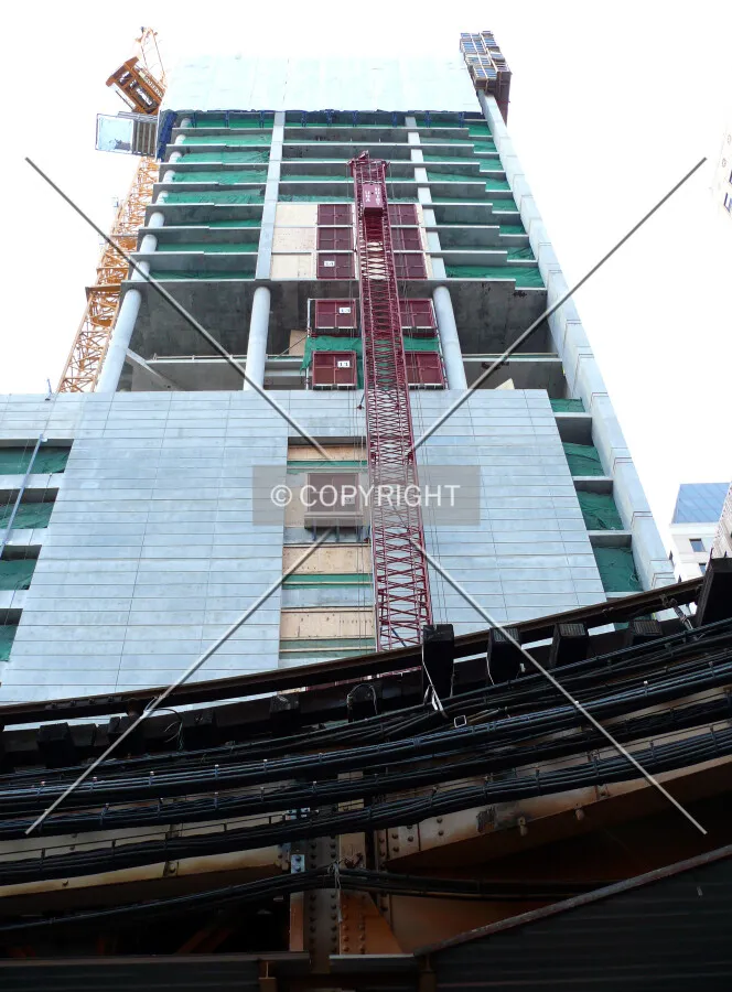 View of the tower rising about the EL tracks as seen from Lake Street