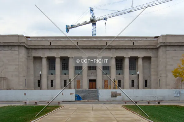 Tower crane rising over the original building, from across St. Clair Street