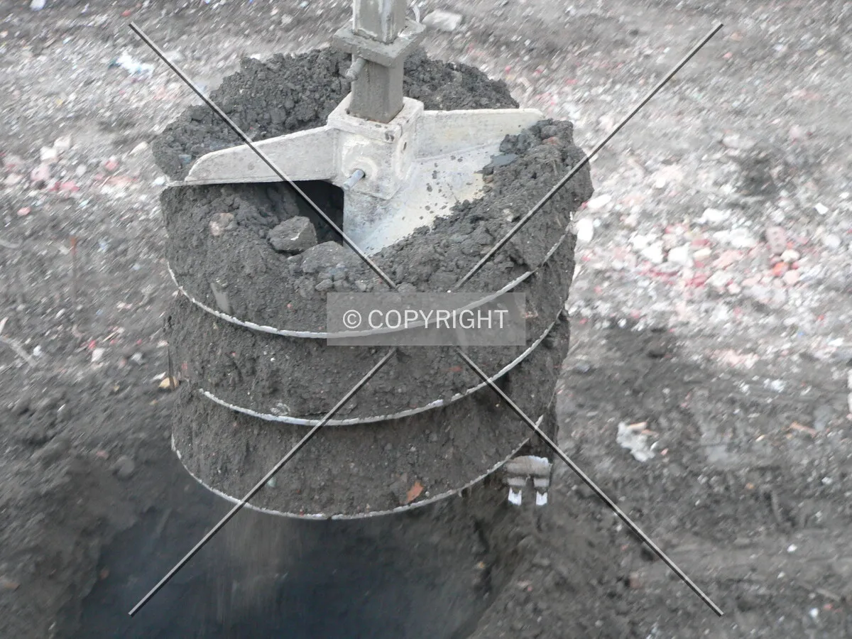 Removing dirt from a caisson hole
