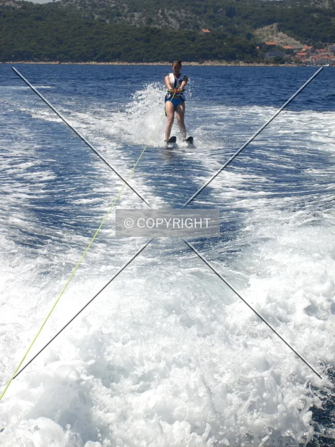 A lady is doing waterskiing