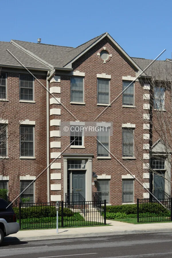 A rowhouse with a brown brick facade